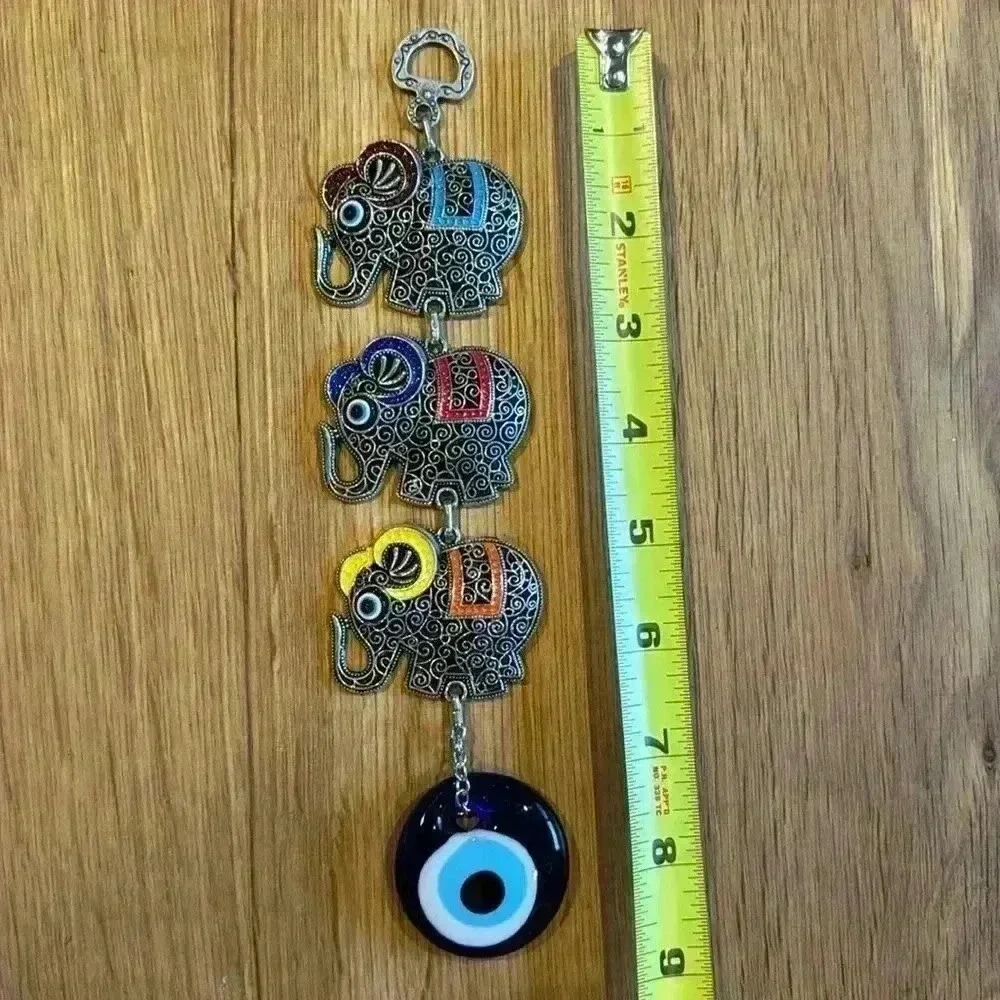 Evil Eye and Elephant wall pendant silver tone with glass evil eye.